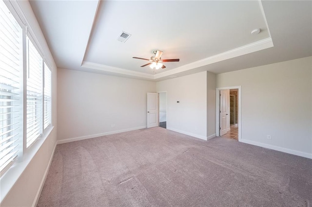 5789 Creek Indian Dr, Sugar Hill, GA 30518 - unfurnished bedroom with a tray ceiling, carpet, baseboards, and a ceiling fan