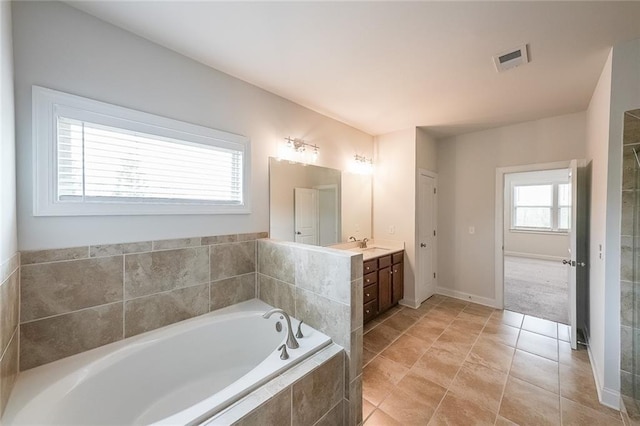 5789 Creek Indian Dr, Sugar Hill, GA 30518 - full bath featuring vanity, a bath, tile patterned flooring, and baseboards
