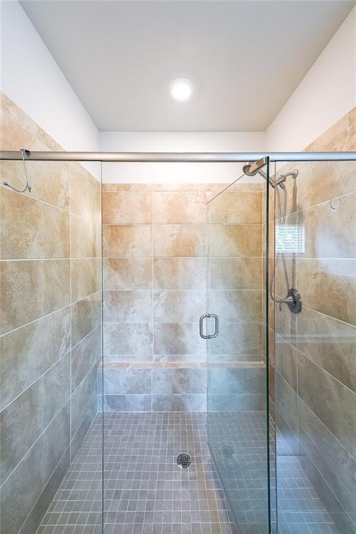 5789 Creek Indian Dr, Sugar Hill, GA 30518 - bathroom with a stall shower
