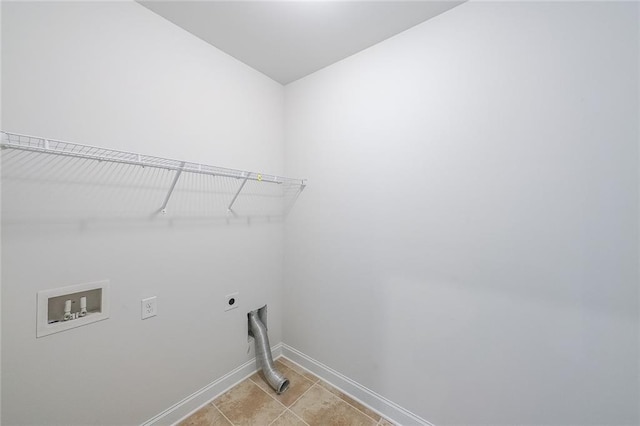 5789 Creek Indian Dr, Sugar Hill, GA 30518 - laundry room featuring hookup for an electric dryer, baseboards, hookup for a washing machine, and light tile patterned floors