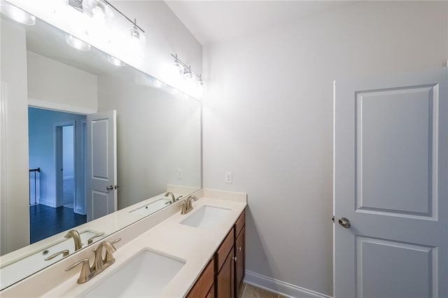 5789 Creek Indian Dr, Sugar Hill, GA 30518 - bathroom featuring double vanity and baseboards