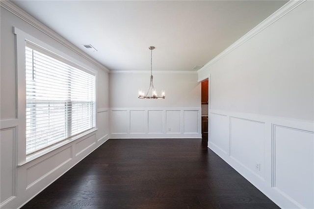 5789 Creek Indian Dr, Sugar Hill, GA 30518 - unfurnished dining area with a chandelier, a decorative wall, crown molding, dark wood-style floors, and a wainscoted wall