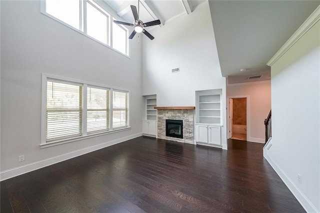 5789 Creek Indian Dr, Sugar Hill, GA 30518 - unfurnished living room featuring ceiling fan, plenty of natural light, baseboards, dark wood-style flooring, and ornamental molding