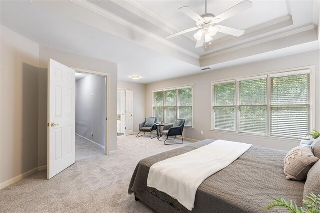bedroom with crown molding, a raised ceiling, light carpet, and baseboards