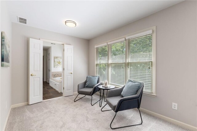 sitting room featuring carpet flooring and baseboards