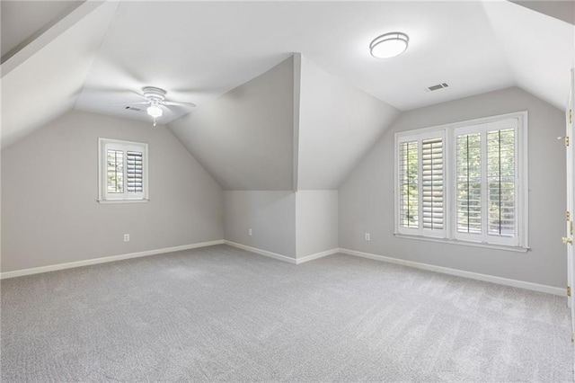 additional living space with carpet, baseboards, lofted ceiling, and a ceiling fan