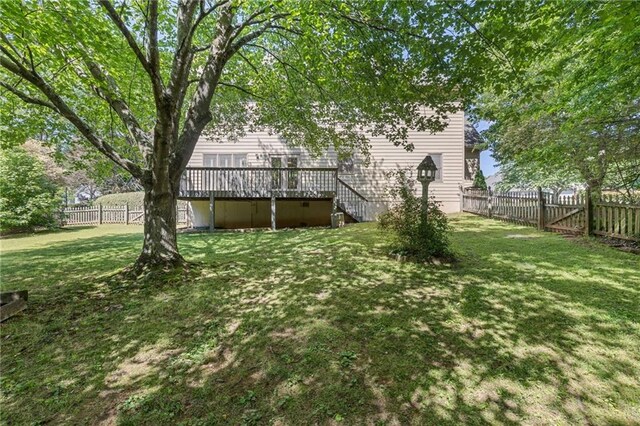 view of yard featuring a wooden deck and stairway
