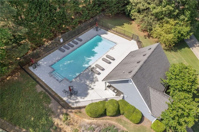 aerial view of property and surrounding area featuring a pool