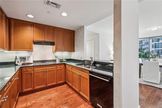 kitchen with cooktop, sink, light wood-type flooring, and black dishwasher