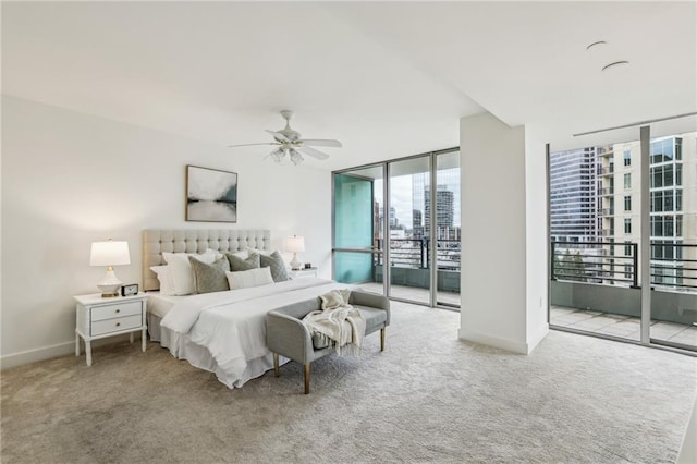 bedroom with ceiling fan, access to exterior, a wall of windows, and light carpet