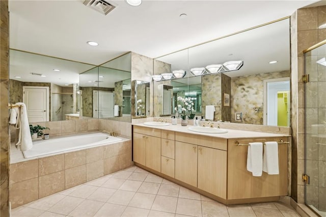 bathroom featuring tile patterned flooring, vanity, and separate shower and tub