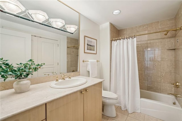 full bathroom with tile patterned floors, vanity, toilet, and shower / bath combo with shower curtain