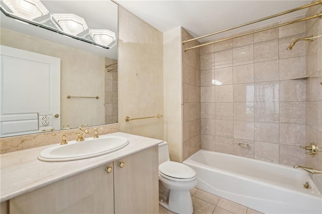 full bathroom featuring tile patterned floors, vanity, toilet, and tiled shower / bath