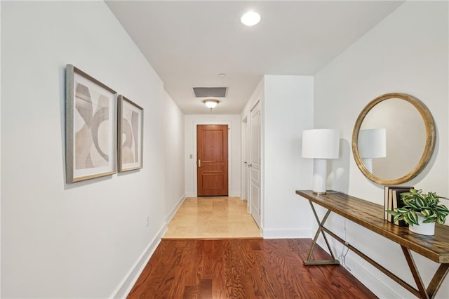 corridor with light hardwood / wood-style floors