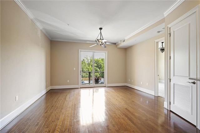 empty room featuring ornamental molding, wood finished floors, baseboards, and ceiling fan