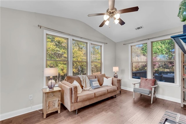 interior space featuring ceiling fan, vaulted ceiling, and dark hardwood / wood-style floors