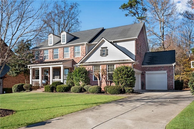 colonial inspired home featuring a porch, a front yard, and a garage