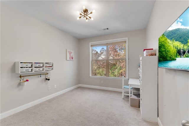 interior space with a chandelier and light carpet