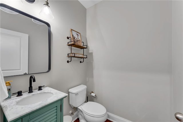 bathroom featuring toilet and vanity