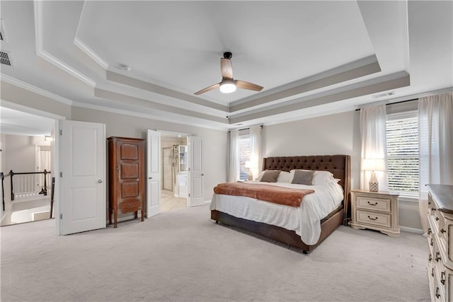 bedroom featuring ceiling fan, a tray ceiling, ornamental molding, and light colored carpet