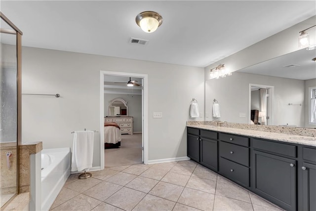 bathroom with vanity, tile patterned floors, a tub to relax in, and ceiling fan