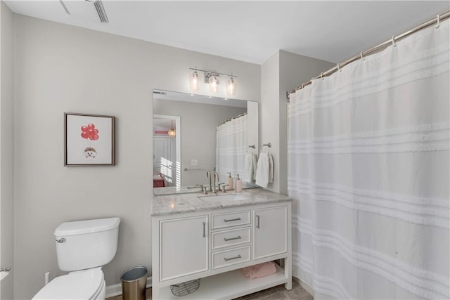 bathroom with toilet and vanity