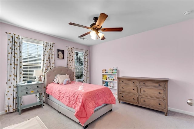 bedroom with ceiling fan and light colored carpet