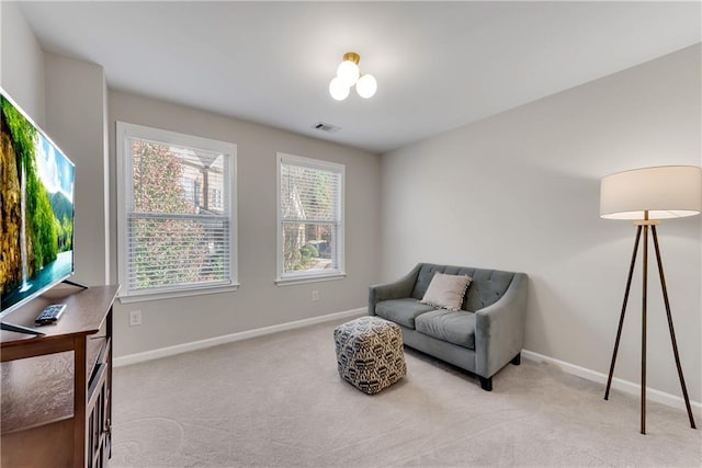 living area with light carpet and plenty of natural light