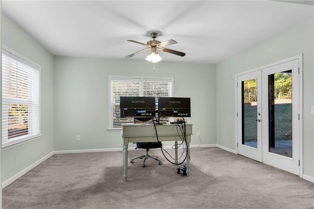 office space with ceiling fan, french doors, a healthy amount of sunlight, and light carpet