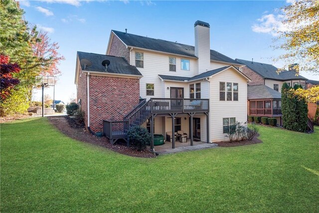 back of property with a patio area, a deck, and a lawn