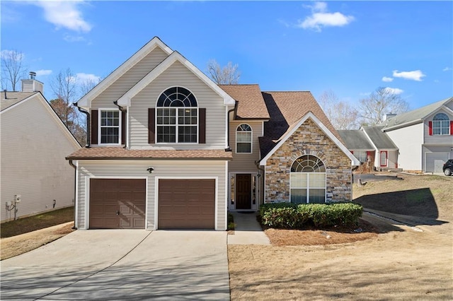 traditional-style house featuring stone siding, concrete driveway, a shingled roof, and an attached garage