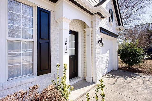 doorway to property with a garage