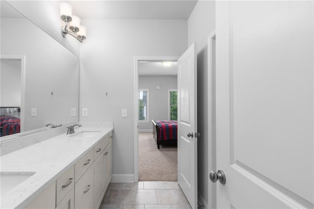 3380 Labrouste Cv, Duluth, GA 30097 - full bathroom with tile patterned flooring, double vanity, baseboards, a sink, and ensuite bath