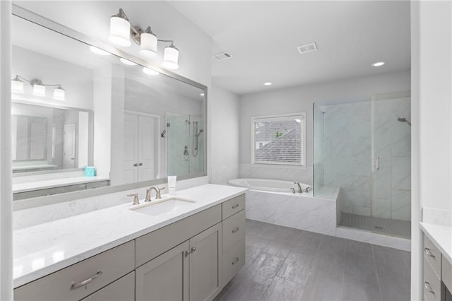 3380 Labrouste Cv, Duluth, GA 30097 - bathroom with vanity, a garden tub, visible vents, recessed lighting, and a marble finish shower