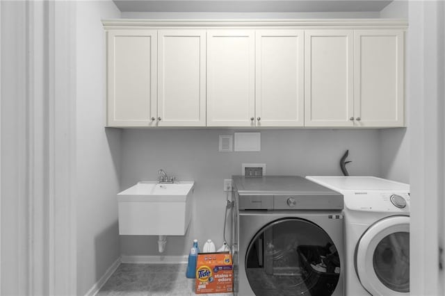 3380 Labrouste Cv, Duluth, GA 30097 - laundry area featuring washer and dryer, baseboards, a sink, and cabinet space