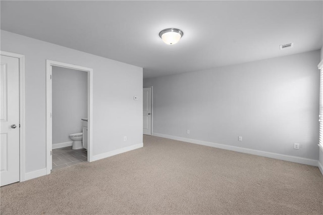 3380 Labrouste Cv, Duluth, GA 30097 - unfurnished bedroom with baseboards, visible vents, ensuite bathroom, and light colored carpet