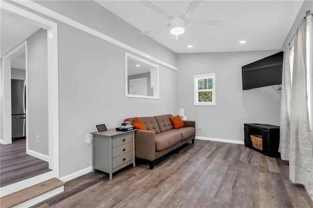 living room featuring ceiling fan, wood-type flooring, and vaulted ceiling