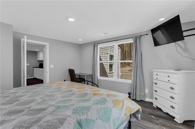 bedroom with dark hardwood / wood-style flooring