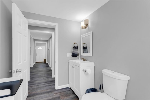 bathroom with vanity, hardwood / wood-style floors, and toilet