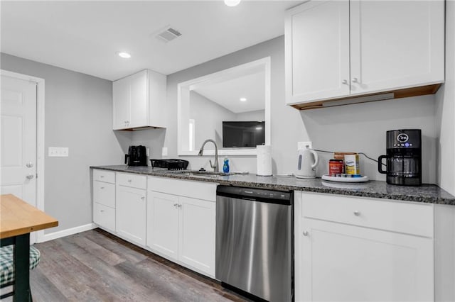 kitchen featuring dark hardwood / wood-style flooring, sink, stainless steel dishwasher, and white cabinets