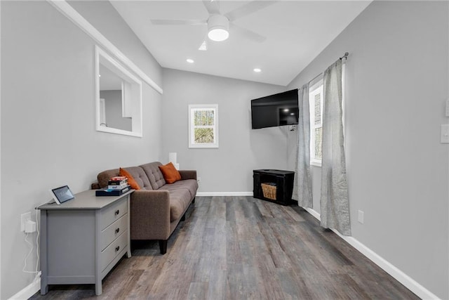 living room with hardwood / wood-style floors, vaulted ceiling, and ceiling fan