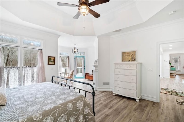 bedroom featuring wood finished floors, baseboards, access to exterior, and crown molding
