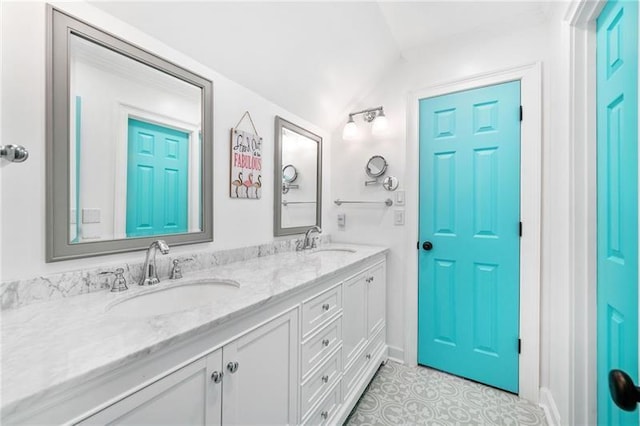 bathroom featuring lofted ceiling, double vanity, and tile patterned flooring