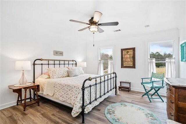 bedroom featuring wood finished floors and baseboards