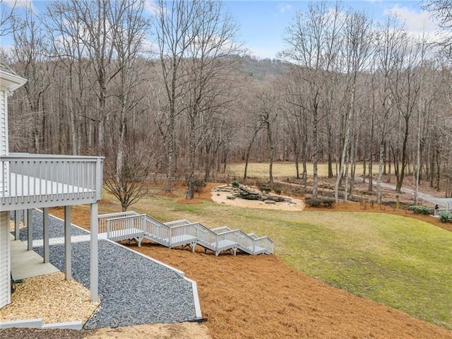 view of green lawn with a deck