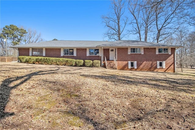 ranch-style home with a front lawn and brick siding