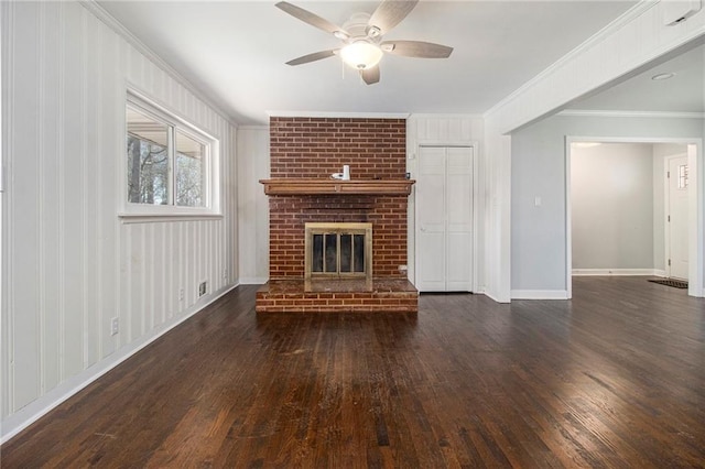 unfurnished living room with crown molding, dark wood-style flooring, a fireplace, and baseboards