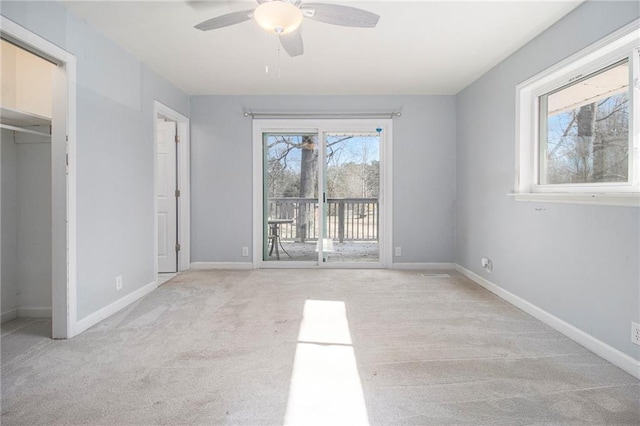 unfurnished bedroom featuring access to outside, light colored carpet, and baseboards