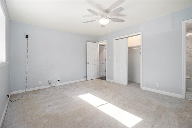 unfurnished bedroom featuring light carpet and baseboards