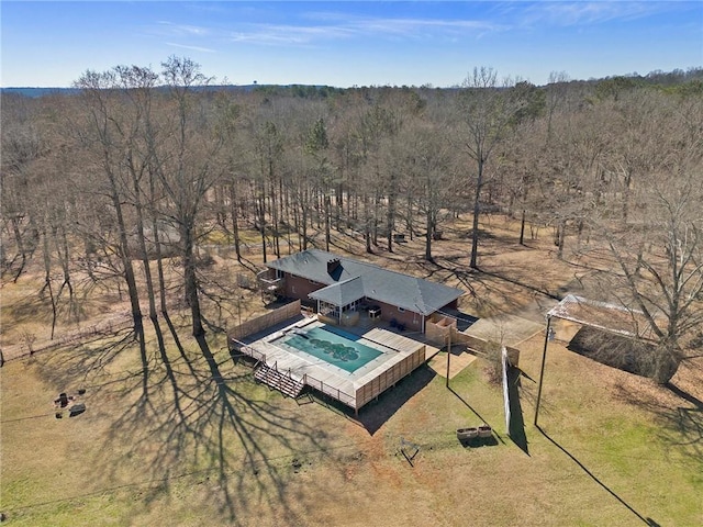 birds eye view of property featuring a view of trees